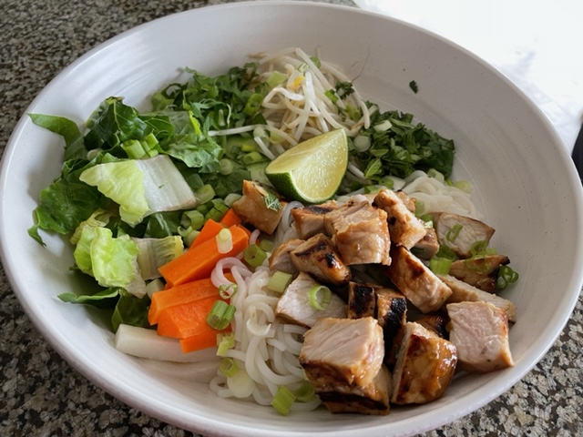 Assembled pork and noodle bowl